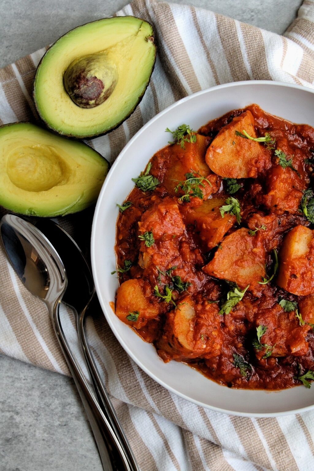 Potatoes stewed in a flavorful sauce with avocado halves. 