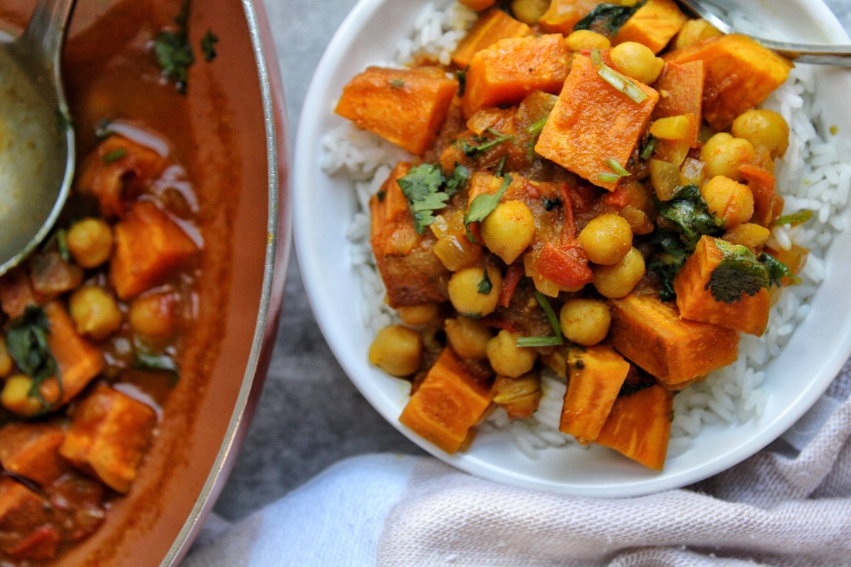 Bowl of sweet potato curry topped with chopped cilantro. 