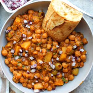 Bowl of Puerto Rican chickpea stew with toasted bread.