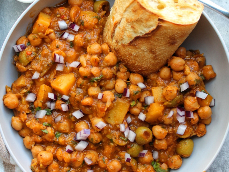 Bowl of Puerto Rican chickpea stew with toasted bread.