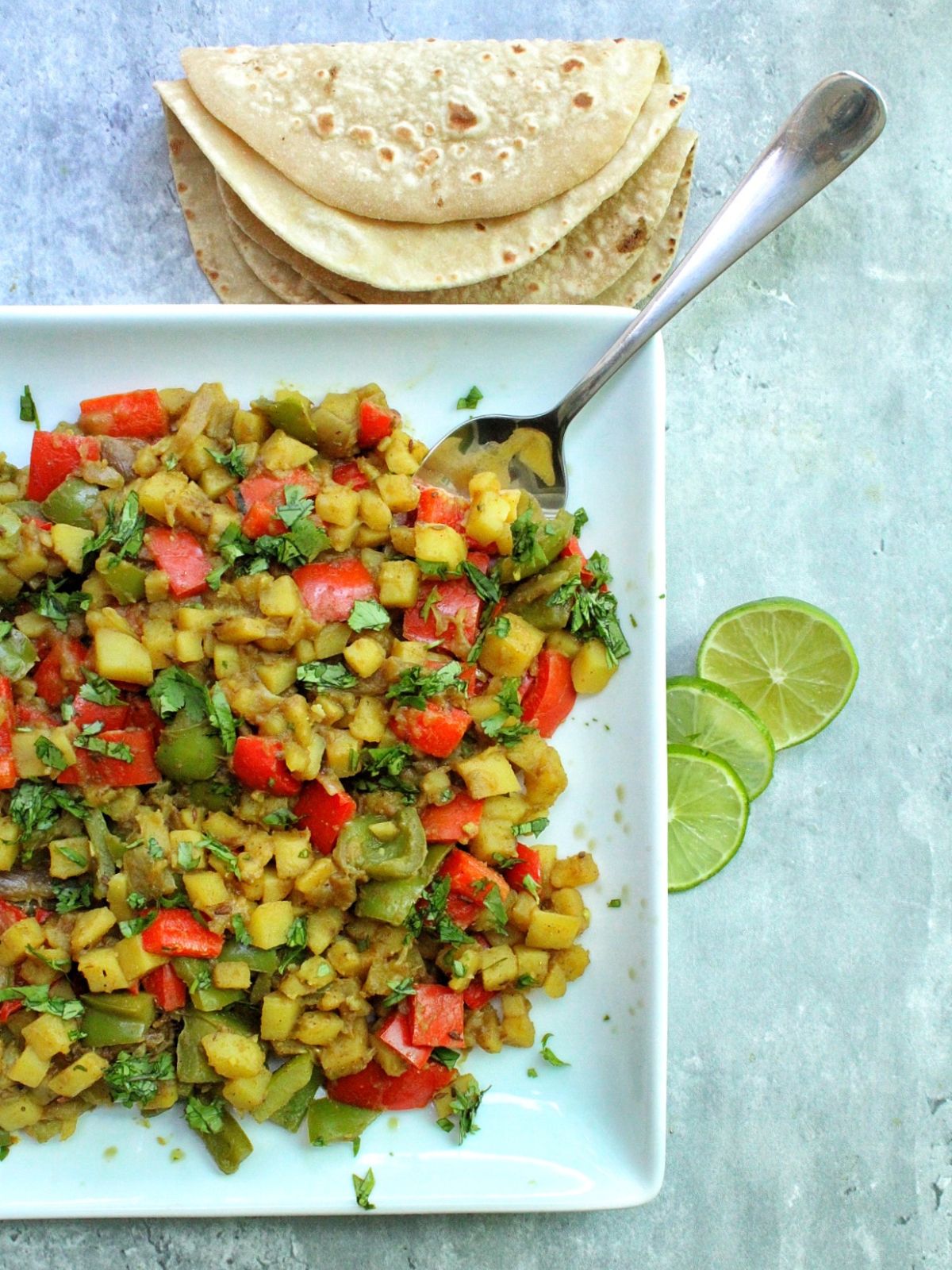 Plate with Aloo Capsicum with lime. 