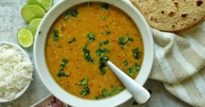 Red lentil soup (Masoor dal) garnished with cilantro.