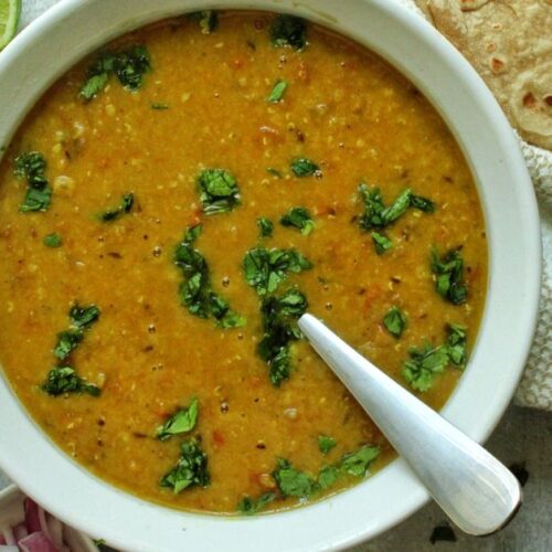 Red lentil soup (Masoor dal) garnished with cilantro.