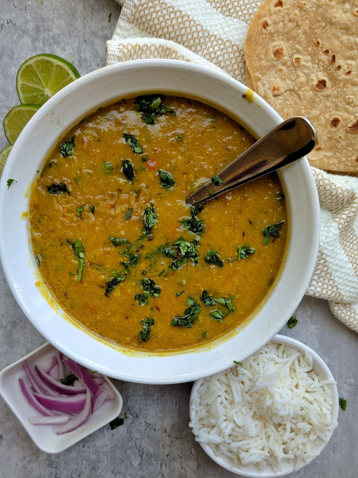 Cooked Red lentil soup garnished with cilantro. 