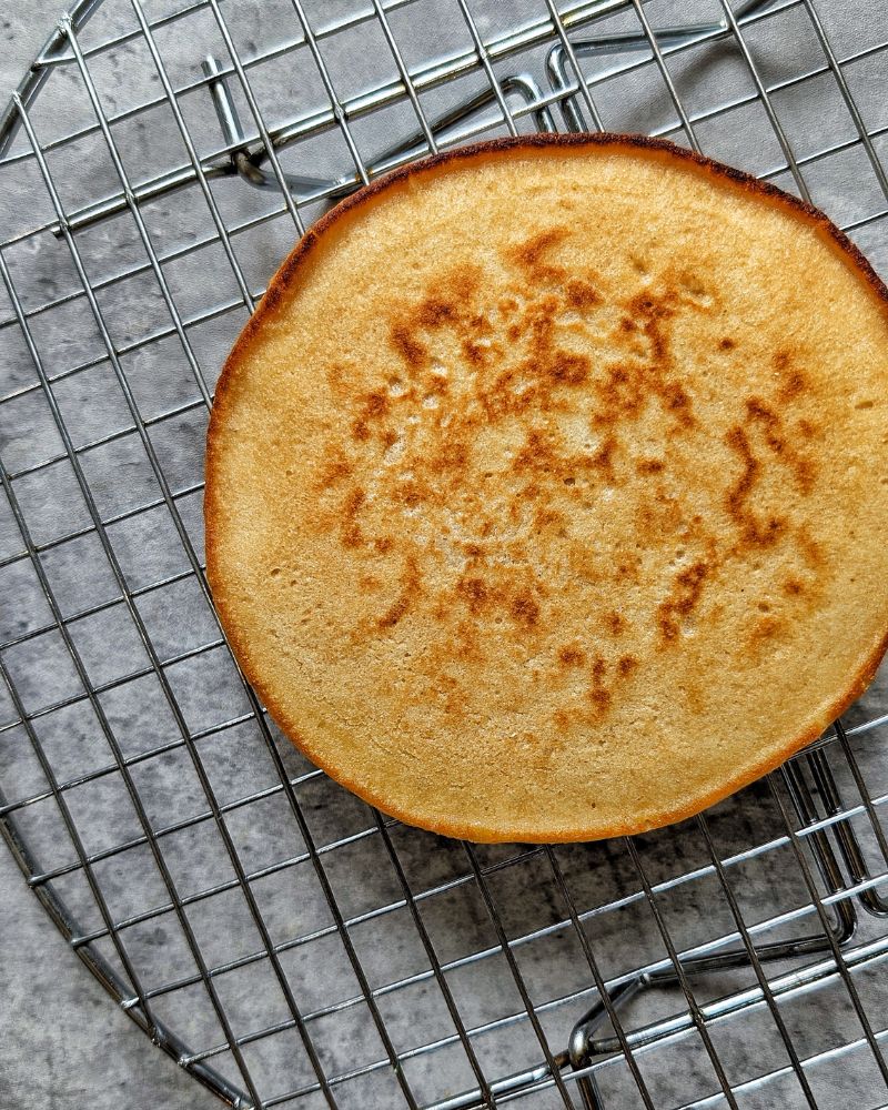 Cooked whole wheat pancakes on a cooling rack. 