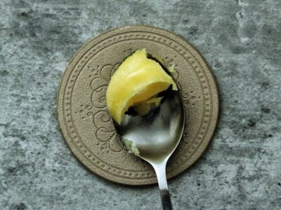 Ghee in solid form on a spoon.