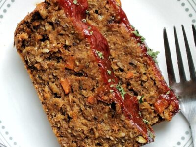 Two slices of vegan lentil loaf on a white plate.