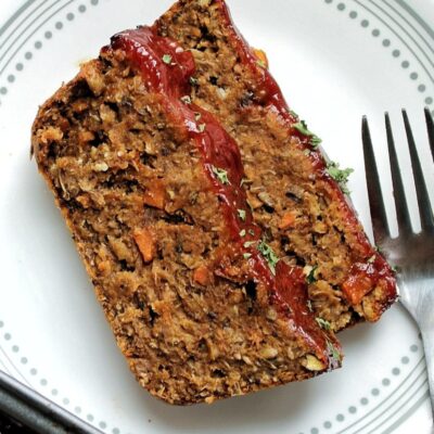 Two slices of vegan lentil loaf on a white plate.