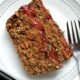 Two slices of vegan lentil loaf on a white plate.