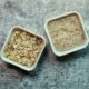 Raw rolled oats and oat bran in white, glass containers.