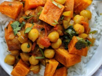 Bowl of savory chickpeas and sweet potatoes over rice.