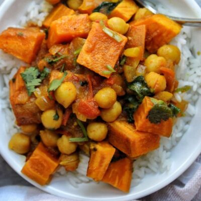 Bowl of savory chickpeas and sweet potatoes over rice.