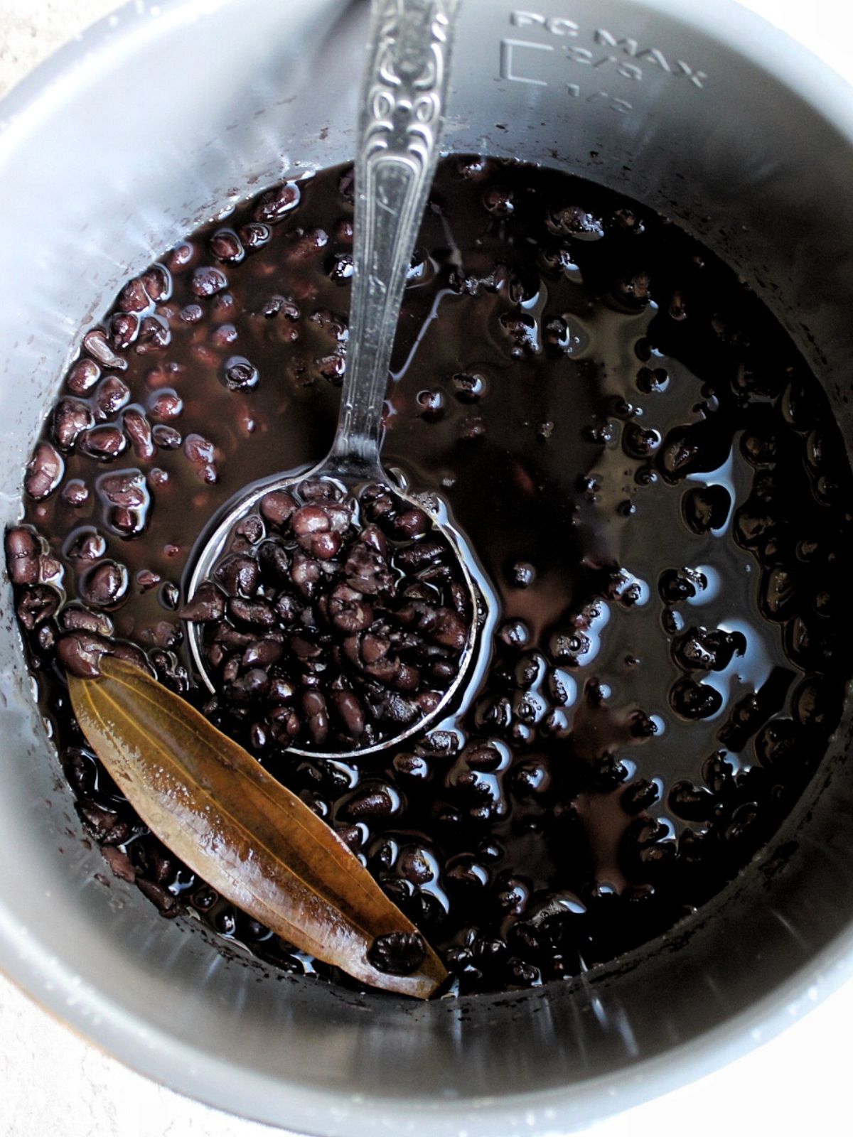 Pressure cooker black beans with a bay leaf.