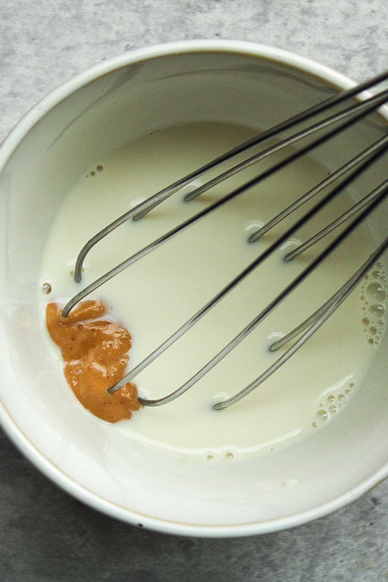 Oat milk with mixed with a dollop of peanut butter. Whisk in photo.